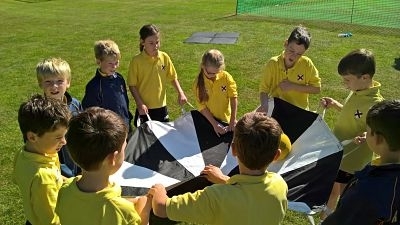 children using parachute for teambuilding purposes
