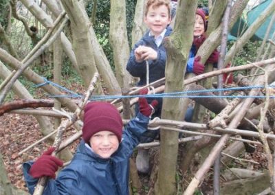 Reception children build a den at forest school
